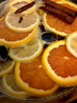 Simmering syrup - remove oranges, lemons & whole spices before dipping cookies!